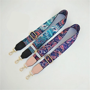 Detail of four ethnic style woven bag straps with gold metal hooks and leather patches