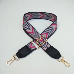 Close-up of adjustable fabric shoulder strap with colorful V-shape wave pattern and gold metal hooks