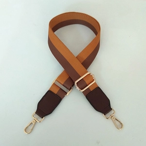 Adjustable two-tone woven shoulder strap with brown leather ends and gold metal clasps