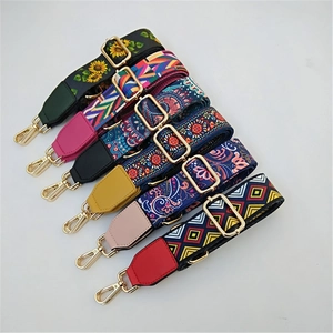 Adjustable ethnic style woven bag straps with floral patterns and gold metal hardware