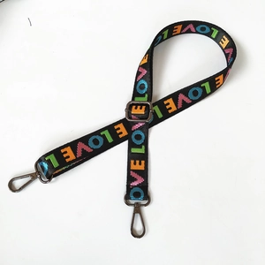 Close-up of adjustable nylon shoulder strap featuring colorful LOVE letter embroidery
