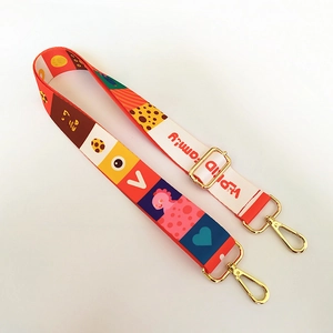 Detail of adjustable nylon strap with colorful cartoon pattern and gold metal buckles