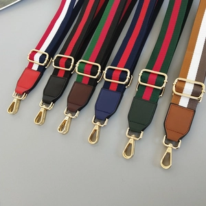 Adjustable striped nylon shoulder straps with leather ends and golden metal hooks