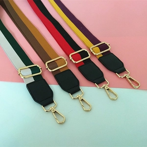 Adjustable canvas shoulder straps with striped patterns and gold metal hardware for handbags