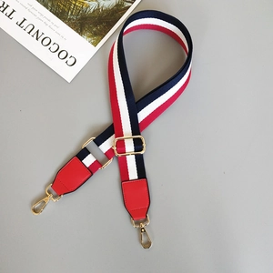 Adjustable striped canvas bag strap with red white and blue pattern and gold metal hooks