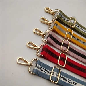 Five assorted colors of adjustable wide woven cotton shoulder straps with gold metal hooks