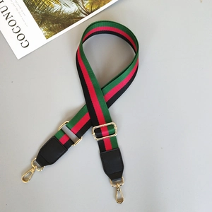 Adjustable green and red striped webbing bag strap with gold metal hooks and black PU leather