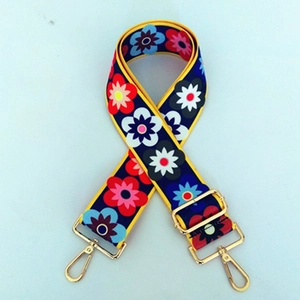 Detail view of ethnic flower print wide nylon strap with golden swivel metal hooks