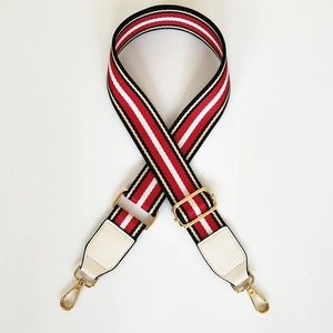Adjustable wide striped shoulder strap with red white black pattern and gold metal hooks
