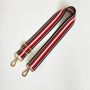 Adjustable red white and black striped replacement shoulder strap with gold metal buckles