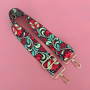 Detail of colorful ethnic wide woven adjustable shoulder strap with gold lobster hooks