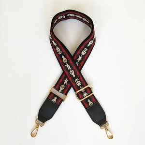 Close-up of ethnic style woven strap with leather ends and golden metal lobster clasps