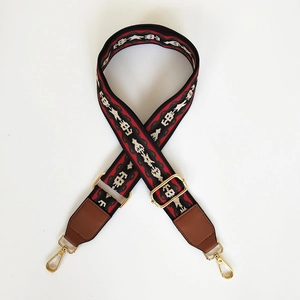 Close-up of ethnic colorful woven bag strap with golden buckles and brown leather ends