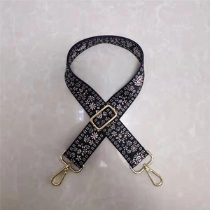 Ethnic style floral wide bag strap with gold metal hooks and adjustable buckle on black base
