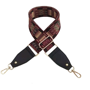 Detailed view of bohemian geometric woven bag strap with golden metal swivel hooks
