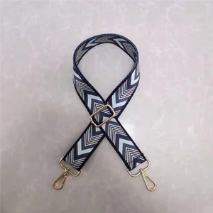 Adjustable woven chevron strap for handbags with gold metal hooks and blue geometric patterns