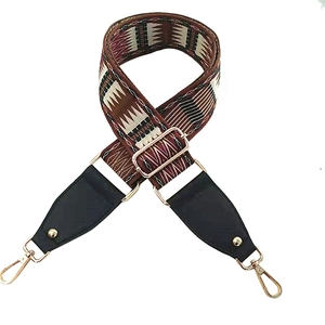 Detail of bohemian geometric woven wide bag strap with gold metal lobster clasps