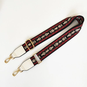 Ethnic woven shoulder strap with colorful geometric patterns and gold metal buckles