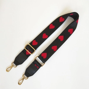 Adjustable wide woven shoulder strap with red hearts and gold swivel hooks