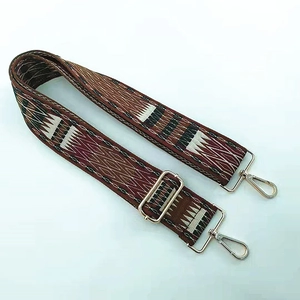 Detail of ethnic geometric woven bag strap with premium gold metal lobster clasps
