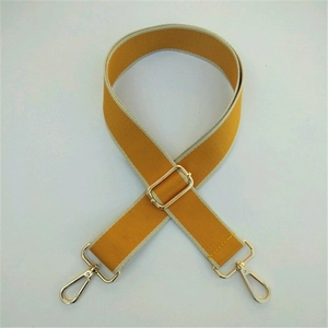 Adjustable mustard yellow canvas bag strap with elegant gold-tone metal hardware
