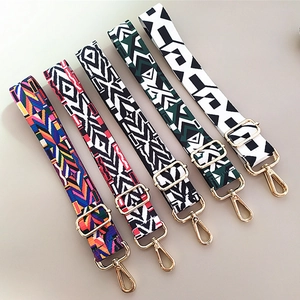 Detailed view of five colorful ethnic geometric wide shoulder straps with gold metal hooks