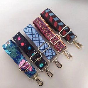 Detail of five colorful adjustable shoulder straps with gold metal hooks for bags