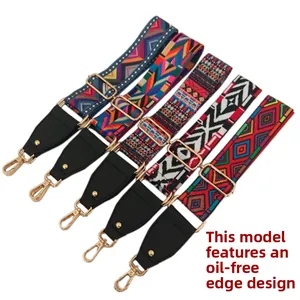 Detail of five ethnic style jacquard bag straps with gold metal hooks and adjusters
