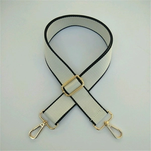 Adjustable wide canvas shoulder strap in off-white with black trim and gold hardware