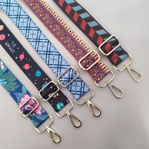 Detail of adjustable ethnic style bag straps with various prints and metal buckles
