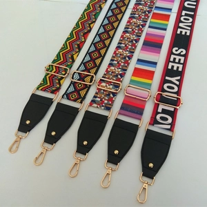 Close-up of five colorful wide replacement bag straps with gold metal clasps and leather ends