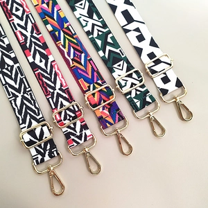 Detail of colorful geometric woven shoulder straps with golden metal hooks and buckles