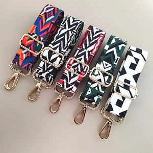 Detail of five colorful ethnic wide adjustable shoulder straps with gold metal hooks