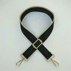 Adjustable wide black fabric shoulder strap with gold metal hooks and beige trim