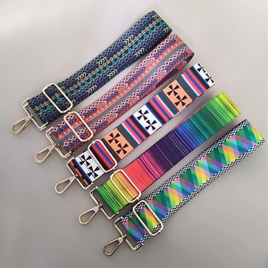 Detail of five bohemian style adjustable wide fabric shoulder straps with gold hardware