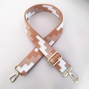 Adjustable geometric woven bag strap with golden metal swivel hooks in white and brown