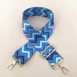Detail view of ethnic blue chevron woven bag strap with adjustable gold lobster clasps