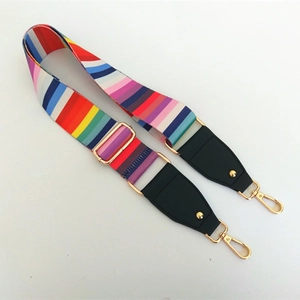 Detail of colorful rainbow striped adjustable shoulder strap with gold metal hooks