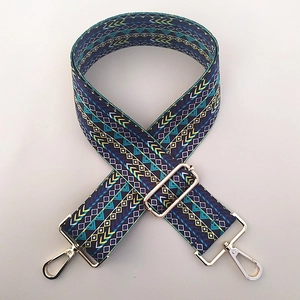 Close-up of wide bohemian patterned shoulder strap with gold metal lobster clasps