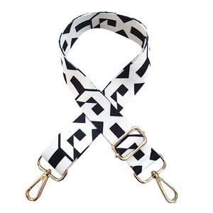 Adjustable wide replacement bag strap with black and white geometric pattern and gold hardware