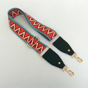 Detail of adjustable ethnic geometric woven bag strap with golden metal swivel hooks