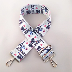 Close-up of adjustable wide canvas shoulder strap with retro Paris Eiffel Tower pattern