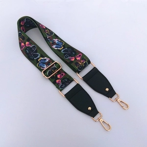 Detail of adjustable butterfly print strap with premium gold hardware and leather ends