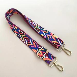 Detail of colorful ethnic geometric woven strap with gold metal buckle for bags