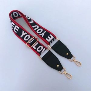 Detail of colorful woven bag strap with LOVE letters and gold metal lobster clasps