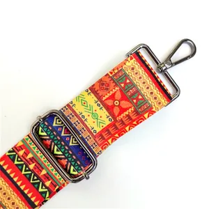 Close-up of bohemian geometric bag strap with dark gunmetal buckle and textured weave