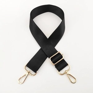 Detail of adjustable black nylon shoulder strap with polished gold-tone metal lobster clasps