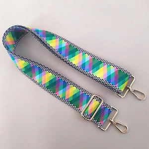 Close-up of ethnic geometric pattern strap with adjustable golden metal buckles