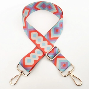 Close-up of bohemian style geometric woven bag strap with golden metal lobster clasps