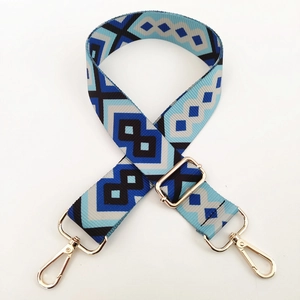 Detail of adjustable geometric jacquard bag strap with gold metal lobster hooks